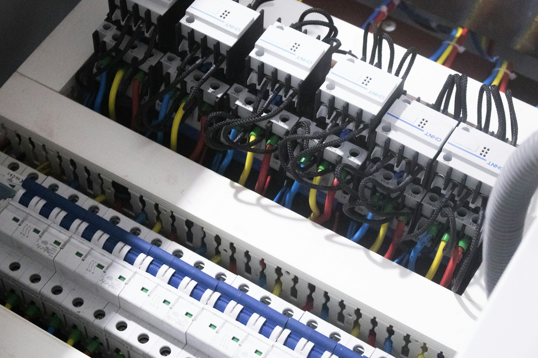 Interior of a residential electrical panel with colored branch-circuit wiring